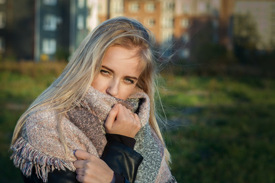 sad pensive blond girl in scarf toned image