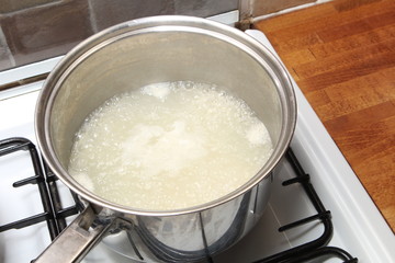 Sauce pan of rice in boiling water on a gas hob