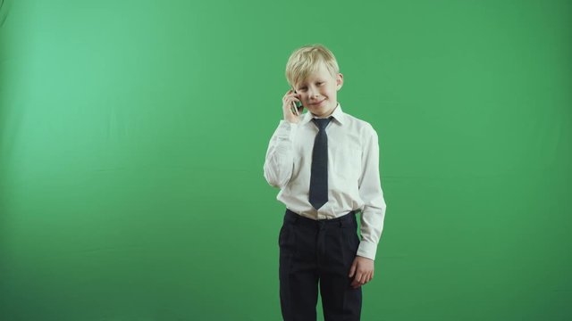 Little boy talking on phone and smiles