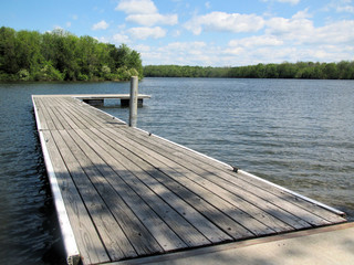 Wooden Dock Extends into Blue Water Lake