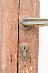 an old wood door with metal handle