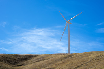 Single wind turbine on top of a hill