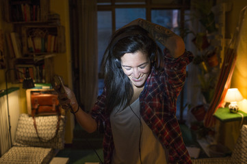Young ginger girl listening to music in headphones