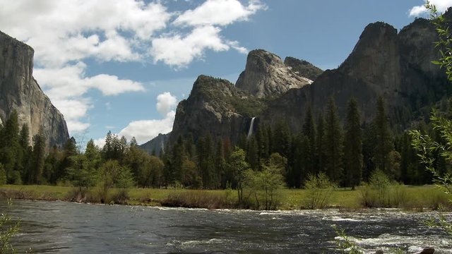 Wide pan of river with mountains in Yosemite National Park