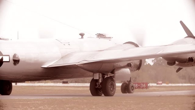 Tracking shot of B29 fighter aircraft moving on the runway