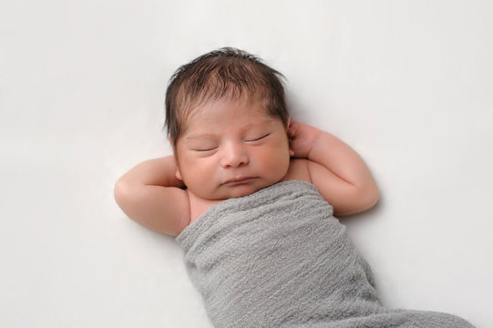 Newborn Baby Boy Swaddled in Gray Wrap