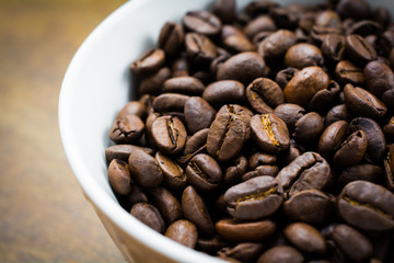 Bowl of Roasted Coffee Beans  on Wood Surface