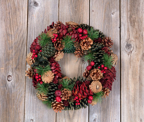 Holiday wreath on rustic wooden boards