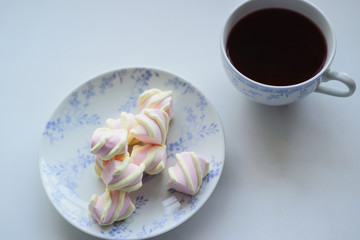 tenderness concept, marshmallow and hot cup of red tea
