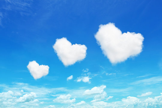 three heart shaped clouds on blue sky