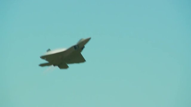 Tracking shot of F22 fighter jet flying in sky