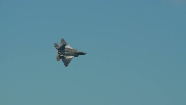 Tracking shot of F22 fighter jet flying in sky