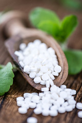 Stevia sweetener on wooden background