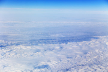 Fototapeta na wymiar View from plane on white clouds