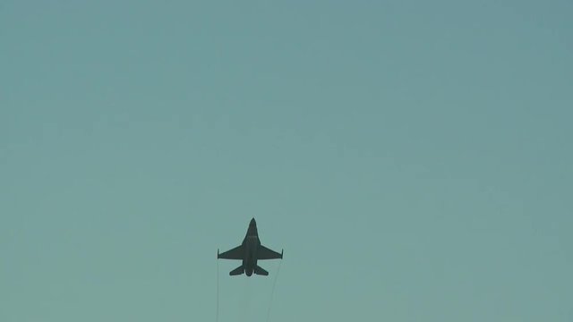 Tracking shot of fighter jet flying in sky