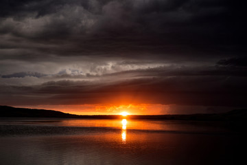 Fototapeta na wymiar Storm Clouds Lake Sunset