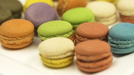 Fototapeta na wymiar Colorful macaron cookies on white background, select and soft focus