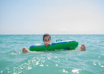 woman splashing water on beach