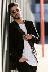 Handsome young man posing in the street.