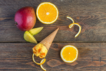 Fresh ripe mango on old wooden table background.
