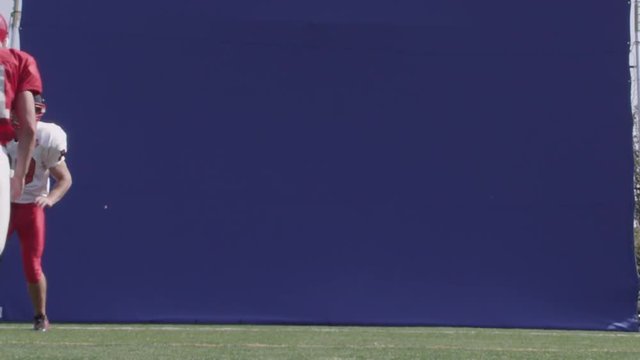 Football bluescreen - football player catches a pass in slow motion.