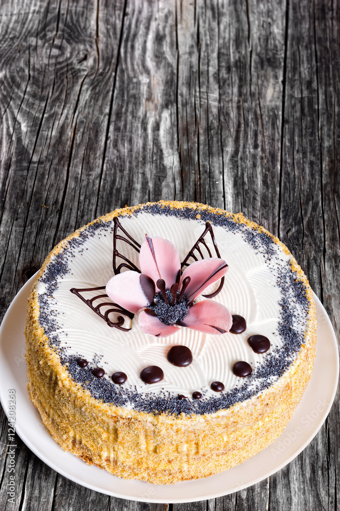 Sticker sponge cake decorated with  icing-sugar beautiful pink flower