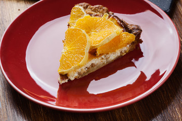Slice of tart with cheese and sliced orange