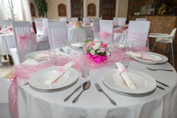 A very nicely decorated wedding table with plates and serviettes. A table set for wedding.