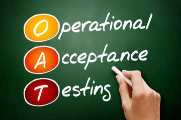 Hand drawn OAT Operational Acceptance Testing, technology business concept on blackboard