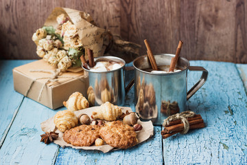 Metal mugs with cacao and marshmallow