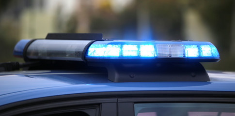 blue flashing of the police car during a chase between cars