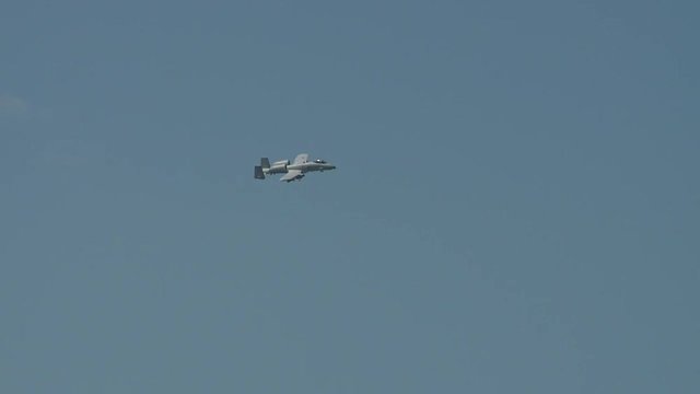 Tracking shot of A10 fighter jet flying in the sky