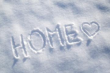 Home word with heart symbol snow background
