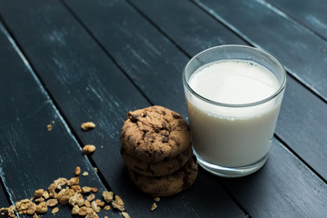 Glass of milk on table on blurred natural background