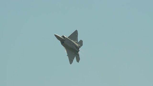 Tracking shot of F22 fighter jet flying in sky