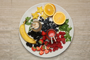 Fruit smoothies with blackberryt, strawberry, mint, orange and banana on white background