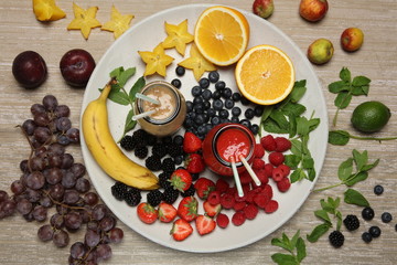 Fruit smoothies with blackberryt, strawberry, mint, orange and banana on white background