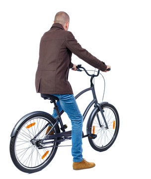 back view of a man with a bicycle. cyclist sits on the bike. Rear view people collection.  backside view of person. Isolated over white background.