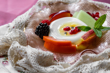 Panna Cotta. Panna Cotta pudding on a plate with freshly sliced fruit.