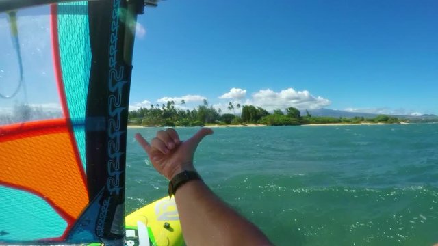 POV windsurfer sailing across blue ocean, extreme sport
