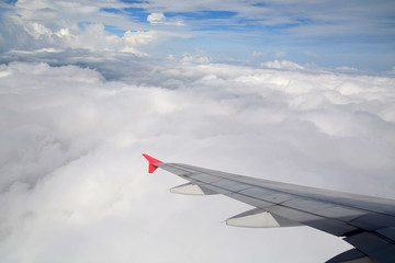 Fototapeta premium Clouds and sky as seen through window of an aircraft