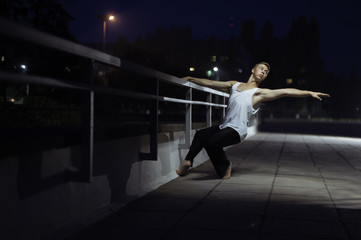 Fototapeta na wymiar Young cute teenager dancing on street background