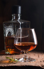 Glass of brandy or cognac and bottle