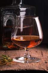 Glass of brandy or cognac and bottle