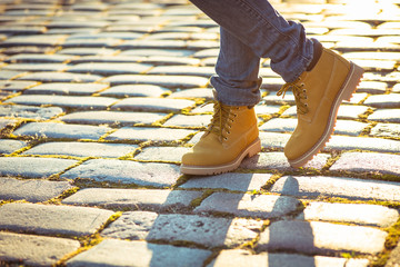 Warm yellow boots. Walking in autumn leaves
