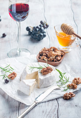 Brie cheese and slice on a wooden board