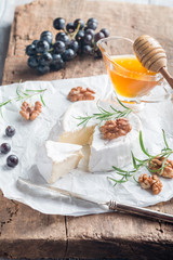 Brie cheese and slice on a wooden board