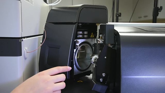 Scientist opens liquid chromatograph mass spectrometer column