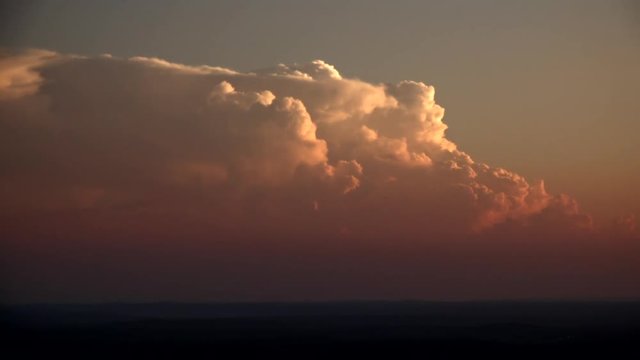 Timelapse of clouds moving in sky during sunset