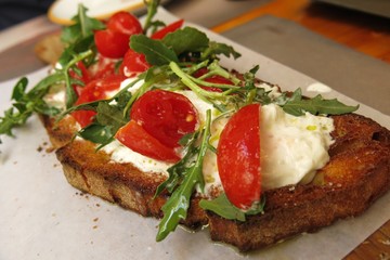 focaccia toast with burrata cheese, tomato and herbs
